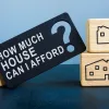 title of how much house can i afford surrounded by wood blocks with homes on them