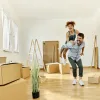excited couple in their new home with moving boxes