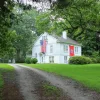 rural home in tennessee with both the US and state flags: down payment assistance