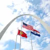 us, missouri, and st louis flags in front of the gateway arch: down payment assistance missouri