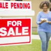 pending home sale sign with real estate agent