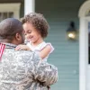 New Law Helps Financially Distressed Veterans Stay In Their Homes Soldier with kid in front of house