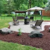 Backyard of a newly purchased home with a nice patio set and landscaping.