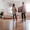 A couple standing in a living room