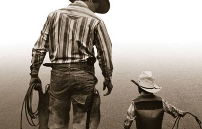 Man and his son dressed as cowboys