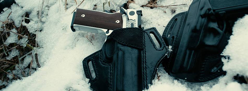 a black outside the waistband holster for 1911 in snow