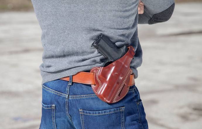 A man carrying an outside the waistband holster