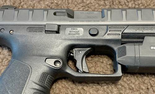 Beretta APX pistol with a tactical light attachment