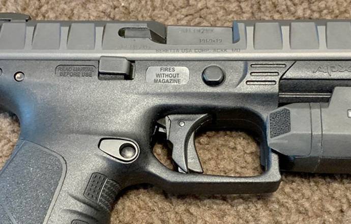 Beretta APX pistol with a tactical light attachment