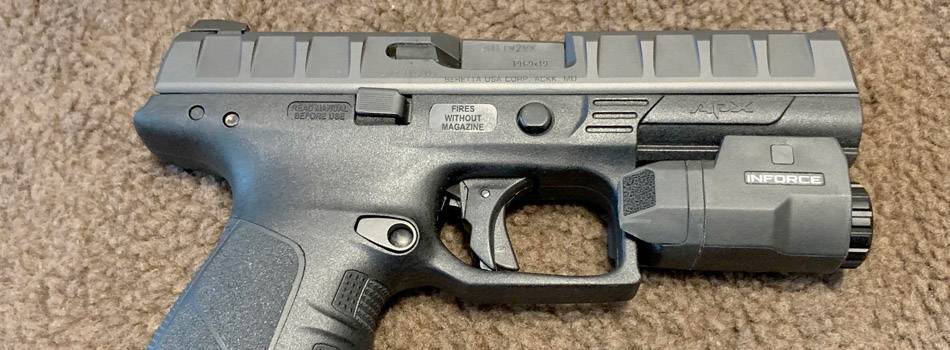 Beretta APX pistol with a tactical light attachment