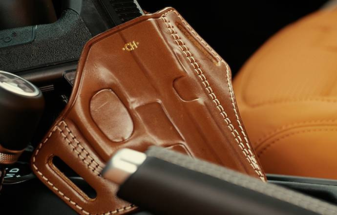 a gun in a holster kept in a car console