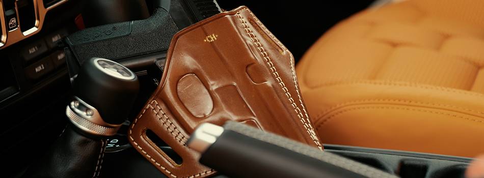 a gun in a holster kept in a car console