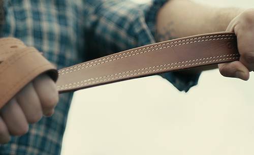 A guy holding a gun belt