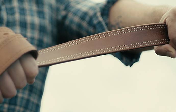 A guy holding a gun belt