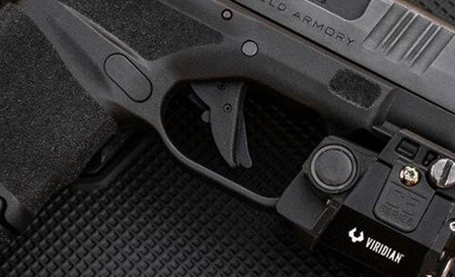 Springfield Armory Hellcat pistol with a flashlight mounted on