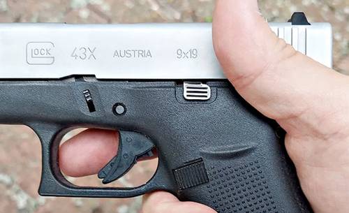 A guy holding Glock 43x Pistol in hand