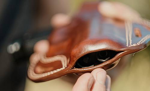 A guy taking showing his leather holster