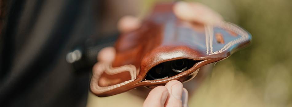 A guy taking showing his leather holster