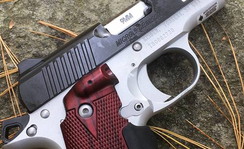 Kimber micro 9 pistol with laser grips