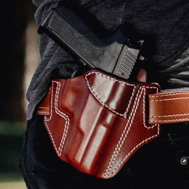 outside the waistband leather holster with a gun in it