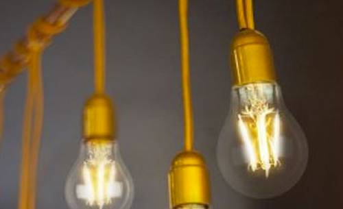 a close up on a line of light bulbs hanging