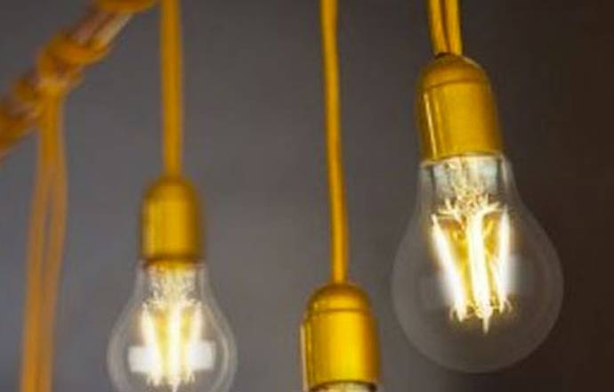 a close up on a line of light bulbs hanging