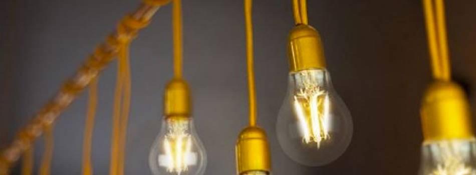 a close up on a line of light bulbs hanging