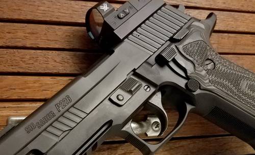 Sig Sauer P226 pistol with a red dot sight