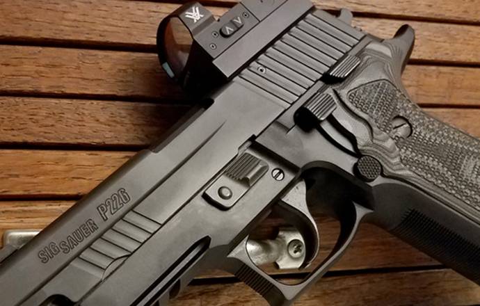 Sig Sauer P226 pistol with a red dot sight