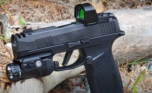 SIG Sauer p365-xmacro pistol with a red dot sight and tactical light attached