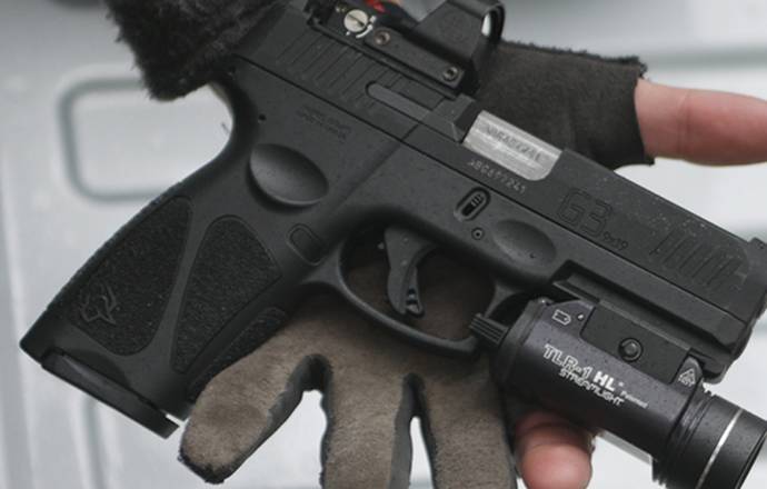 Taurus G3c pistol with a streamlight tlr-1 tactical light and laser combo