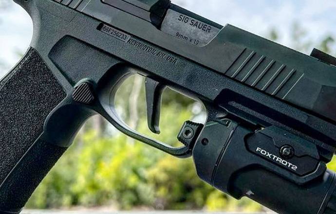 SIG Sauer p365-Xmacro pistol with a tactical light mounted to its rail