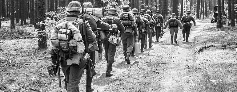 German soldiers marching through a forest