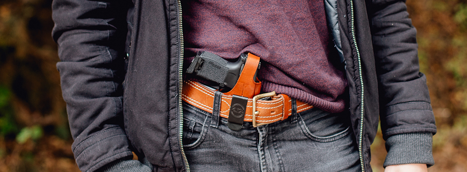 a guy carrying a concealed carry holster and his 9mm gun