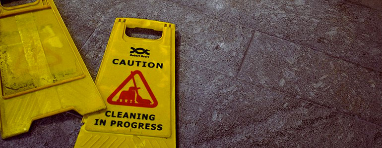 Yellow wet floor sign laying on the floor