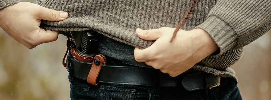 A guy concealing his S&W M&P Shield in an IWB holster