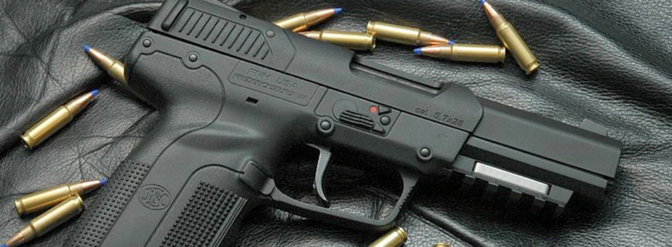 FN five seven pistol on a desk