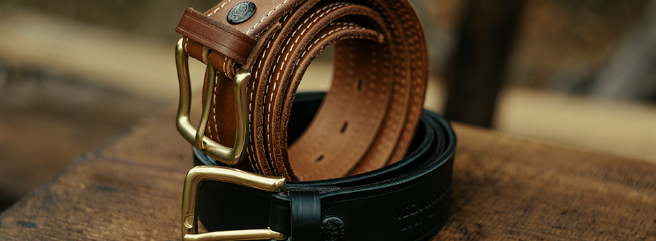 two leather gun belts one black one mahogany