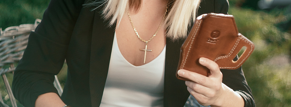 a woman selecting a new leather holster