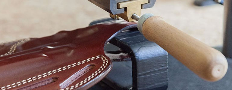 Stamping tool embossing a leather holster