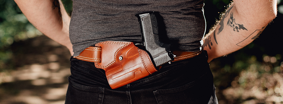 a guy showing his small of back holster