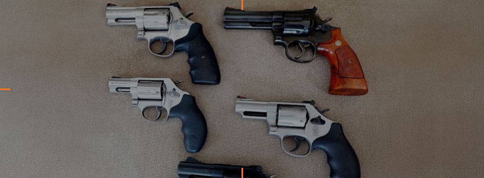 Four Smith & Wesson revolvers with different barrel lengths and grip styles displayed together.