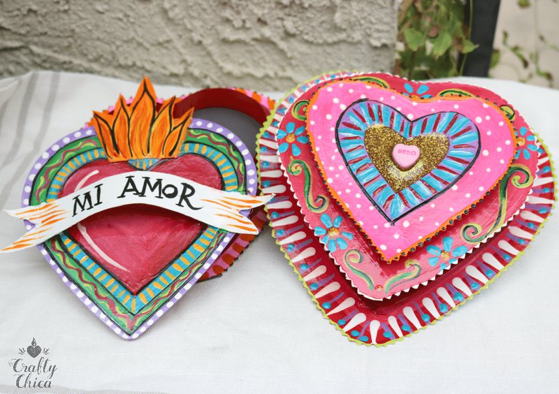 Two colorful decorated heart-shaped candy boxes.