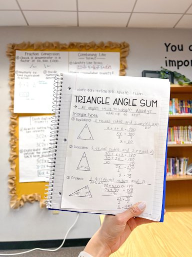 Stephanie holds a worksheet called “Triangle Angle Sum” and featuring angle calculations for equilateral, iscsceles, and scalene triangles.