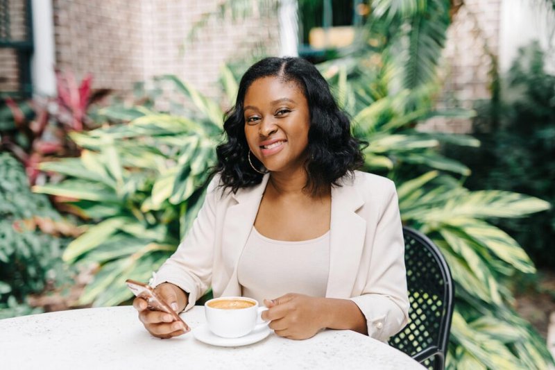 Nakisha Wynn sitting at a table with coffee
