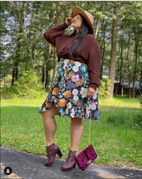 Nikki Apostolou wearing a flower shirt and a brown sweater