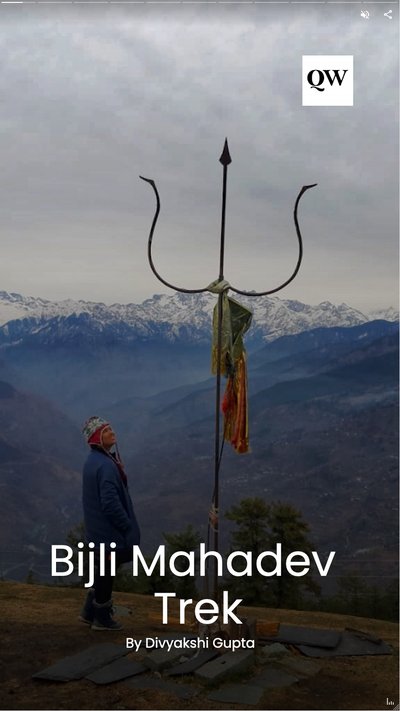 A person standing on a mountaintop next to a temple