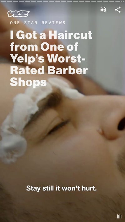 A person laying back in a stylist chair getting a haircut