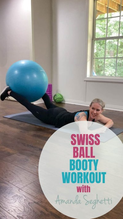 A person laying on a yoga mat performing an exercise with a ball