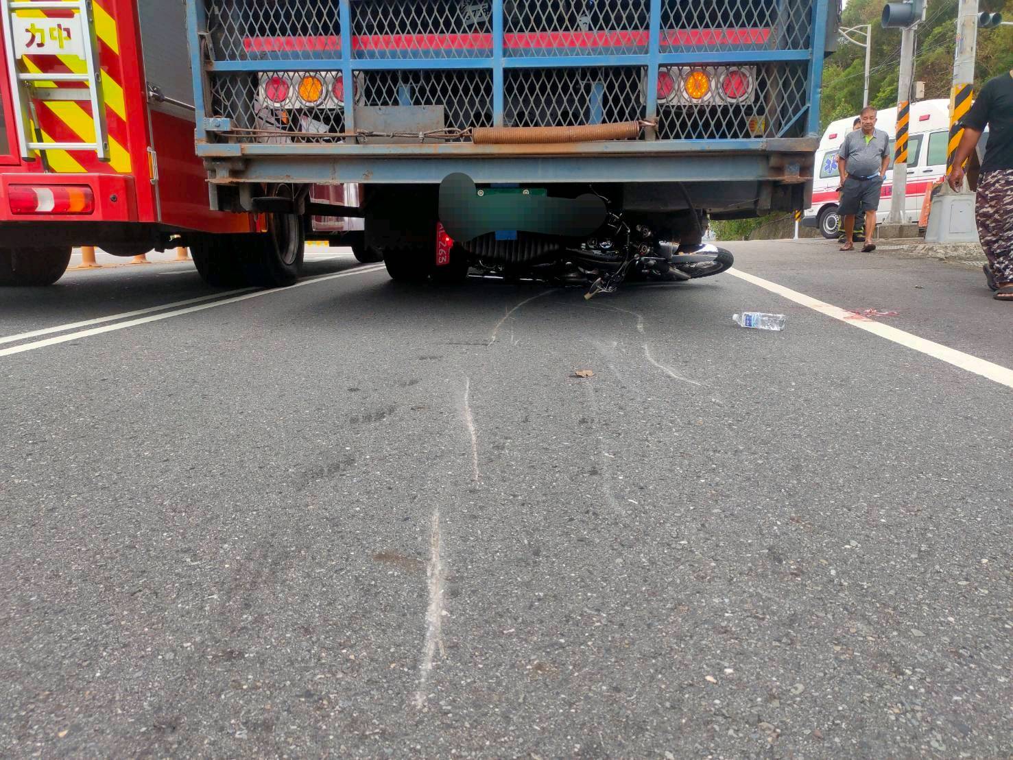 陳姓男子的重機卡在貨車車底。（圖／警方提供）